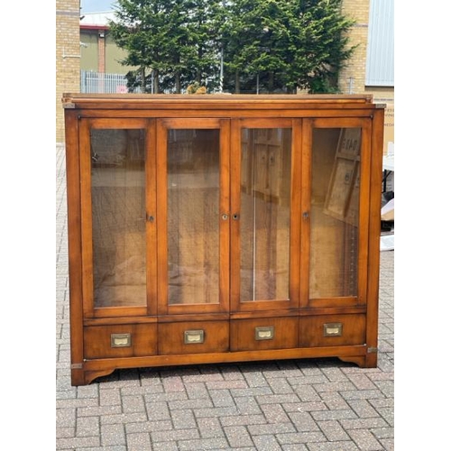 25 - ANTIQUE DISPLAY CABINET WITH TWO GLASS SHELFS AND FOLDING GLASS FRONT DOORS AND BRASS FITTINGS, FITT... 