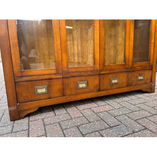 25 - ANTIQUE DISPLAY CABINET WITH TWO GLASS SHELFS AND FOLDING GLASS FRONT DOORS AND BRASS FITTINGS, FITT... 