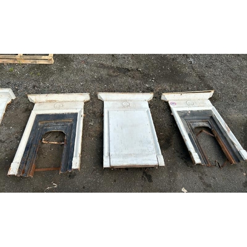 1051 - THREE MATCHING PAINTED CAST IRON FIREPLACE SURROUNDS AND INSERTS, ALL WITH FLORAL CREST, OUTER DIMEN... 