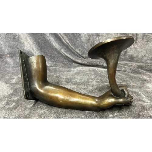 24 - A BRASS WALL CANDLE HOLDER IN THE FORM OF AN ARM AND HAND, WITH BRONZE EFFECT PATINA, 30CM LONG / 76... 