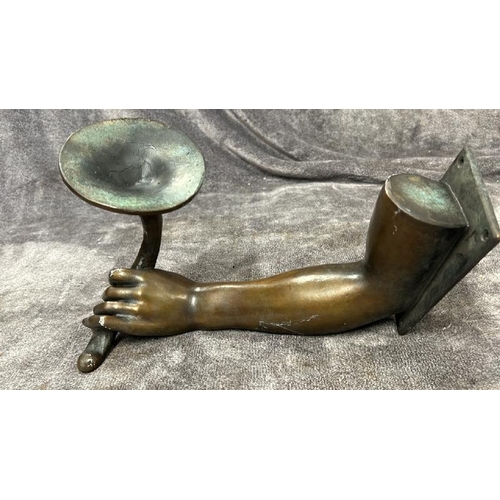 24 - A BRASS WALL CANDLE HOLDER IN THE FORM OF AN ARM AND HAND, WITH BRONZE EFFECT PATINA, 30CM LONG / 76... 