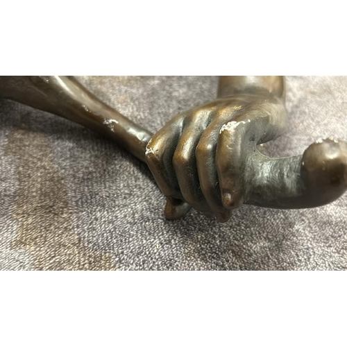 24 - A BRASS WALL CANDLE HOLDER IN THE FORM OF AN ARM AND HAND, WITH BRONZE EFFECT PATINA, 30CM LONG / 76... 