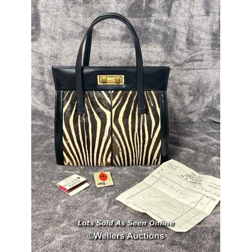 43 - A vintage Zebra skin handbag with original receipt dated 19th September 1966 and two vintage matchbo... 