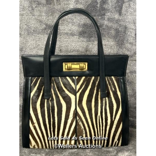 43 - A vintage Zebra skin handbag with original receipt dated 19th September 1966 and two vintage matchbo... 