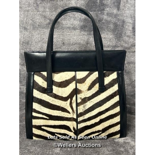 43 - A vintage Zebra skin handbag with original receipt dated 19th September 1966 and two vintage matchbo... 