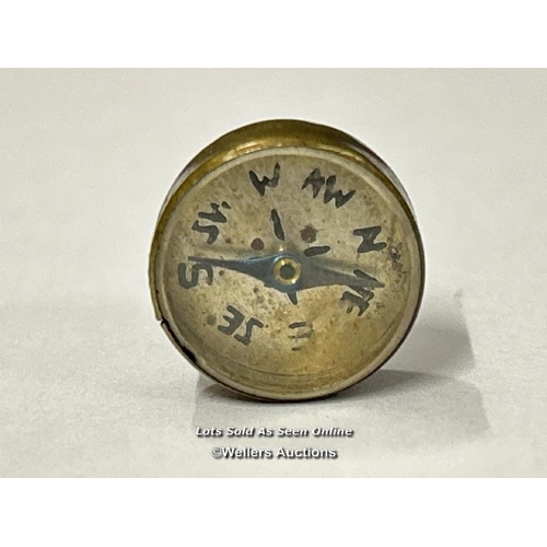 76 - Two very small brass compasses, both 1.5cm diameter. One has Chinese numerals with a printed clock o... 