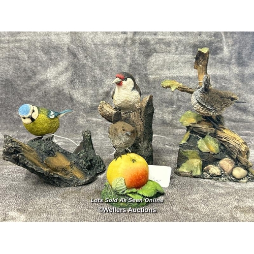 97 - A collection of four Arden Sculptures by Christopher Holt, including Wren on Apple, Wren, Bluetit an... 