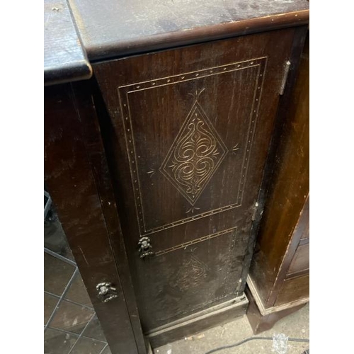 15 - An oak cupboard with carved side panels and glass display centrepiece, not including internal conten... 