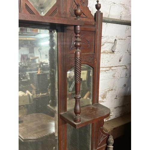 18 - A carved Victorian wall mirror, flanked by two shelves and one above, 108cm high x 87cm wide