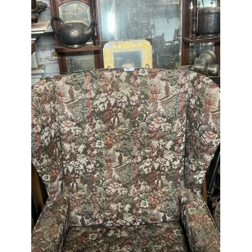 20 - A reproduction upholstered armchair, 110cm high x 70cm wide x 70cm deep