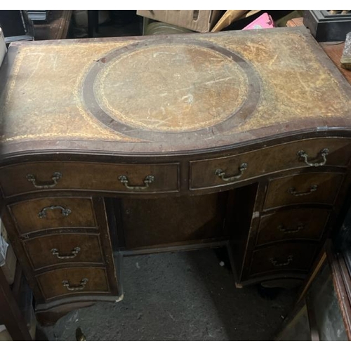 31 - A bow fronted oak desk with leather top inlay, 77cm high x 91cm wide x 52cm deep