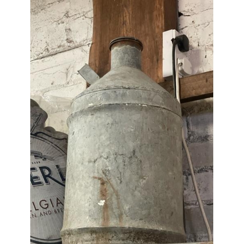 38 - A galvanised milk jug, 56cm high