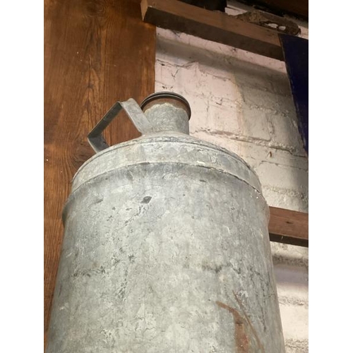 38 - A galvanised milk jug, 56cm high