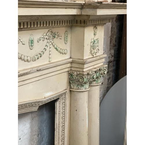 47 - A large and ornately carved wooden fire surround, in the style of Robert Adams, with drapery feature... 