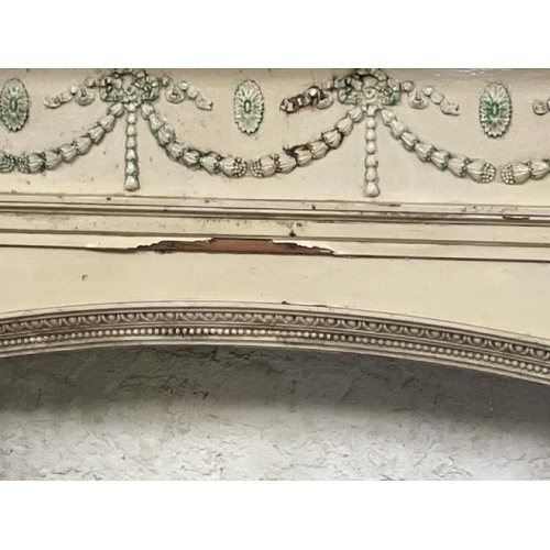 47 - A large and ornately carved wooden fire surround, in the style of Robert Adams, with drapery feature... 