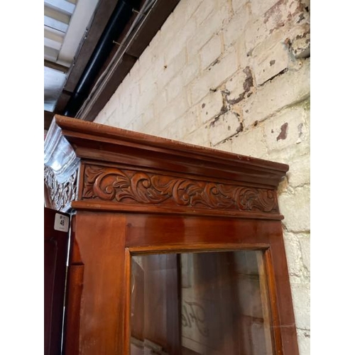 48 - An ornately carved display cabinet with two internal shelves and two drawers underneath, 197cm high ... 