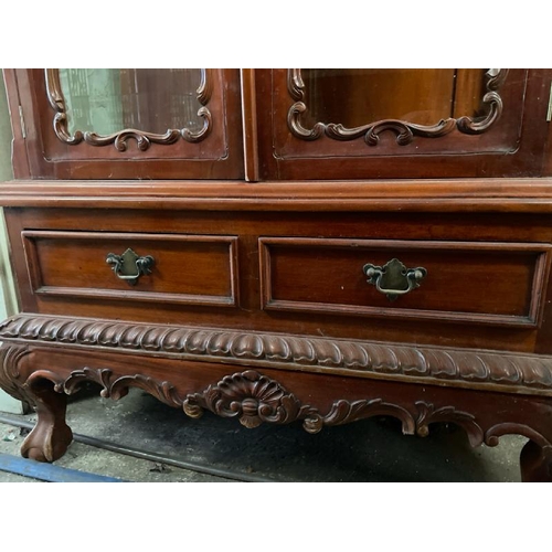 48 - An ornately carved display cabinet with two internal shelves and two drawers underneath, 197cm high ... 