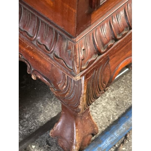 48 - An ornately carved display cabinet with two internal shelves and two drawers underneath, 197cm high ... 