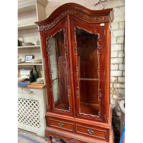 48 - An ornately carved display cabinet with two internal shelves and two drawers underneath, 197cm high ... 