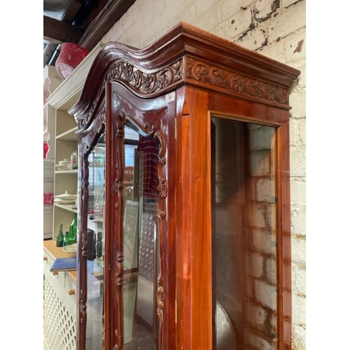 48 - An ornately carved display cabinet with two internal shelves and two drawers underneath, 197cm high ... 