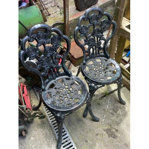 53 - A pair of cast iron garden chairs, 82cm high