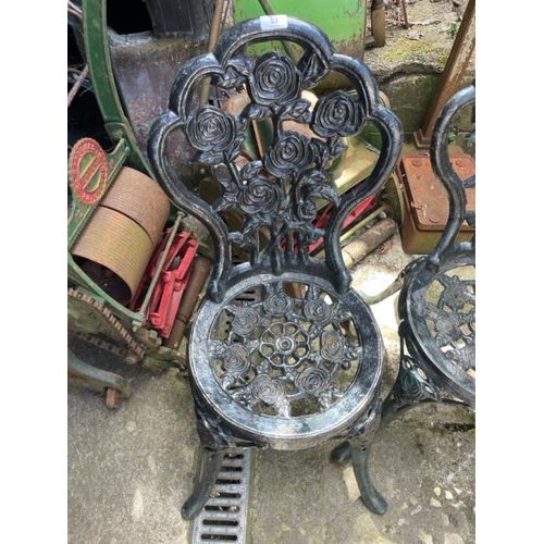 53 - A pair of cast iron garden chairs, 82cm high