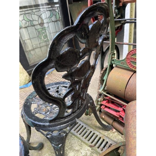 53 - A pair of cast iron garden chairs, 82cm high