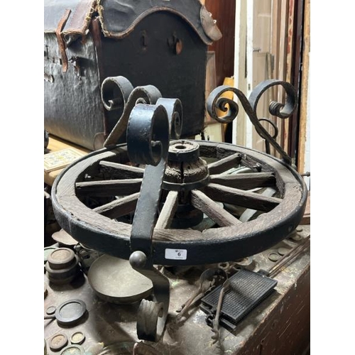 6 - A decorative wooden cart wheel with cast iron rim and wrought iron fixtures, 50cm high x 65cm diamet... 