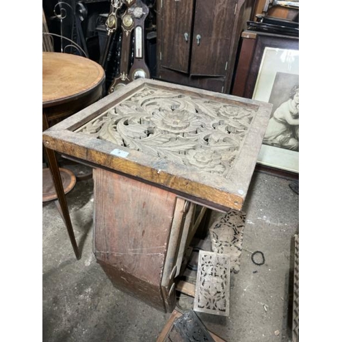 9 - A decorative wooden table with carved centrepiece, converted to electric, with associated panelling,... 