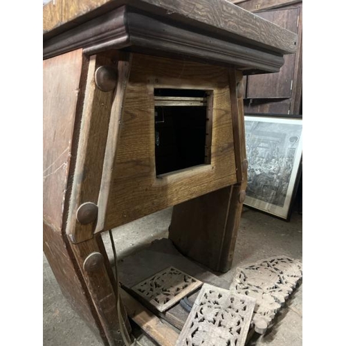 9 - A decorative wooden table with carved centrepiece, converted to electric, with associated panelling,... 