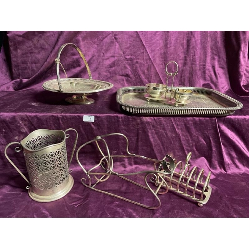 1 - Assorted silver plate including a toast rack, bottle holder, tray etc  / All lots are located at The... 