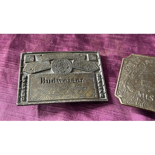 102 - Two belt buckles, Budweiser and Queen of the West  / All lots are located at The Barn, Hampstead Far... 