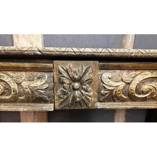 394 - A gothic revival/jacobean style profusely carved oak hallway/console table on lion legs, 75cm (h) x ... 