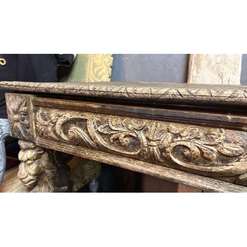 394 - A gothic revival/jacobean style profusely carved oak hallway/console table on lion legs, 75cm (h) x ... 