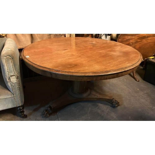 468 - A 19th century mahogany circular dining table on triform base with finely carved claw feet and origi... 