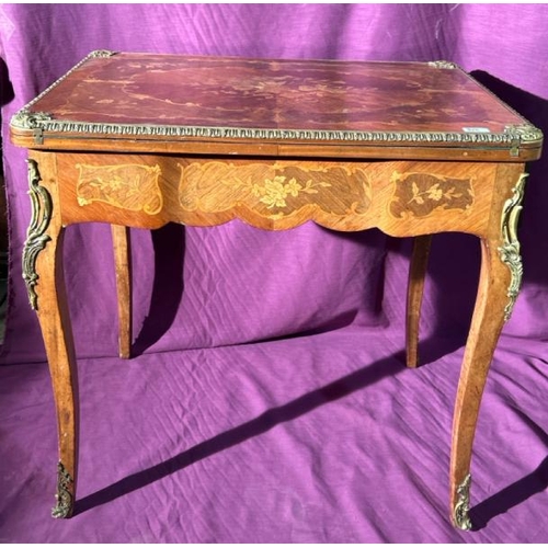 475 - A 20th century Louis XV style metamorphic games table with profuse floral inlay using exotic timbers... 