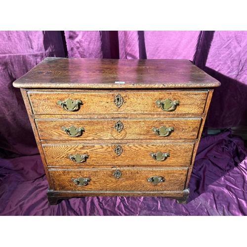 477 - An 18th century bachelors chest of four graduated drawers on bracket feet in oak, with good color an... 