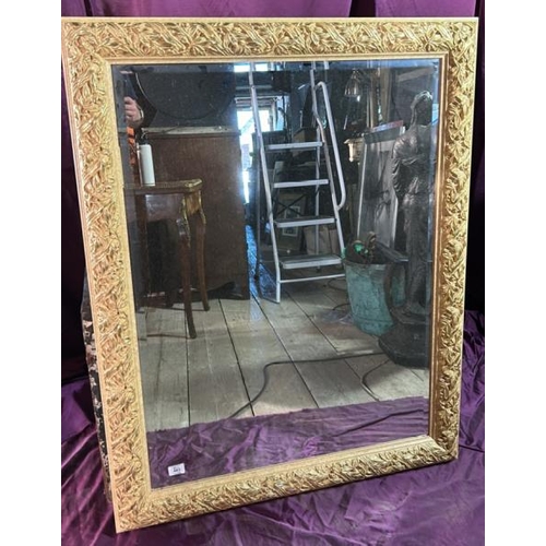 483 - A 20th century mirror with beviled edge and profuse floral gilt frame, 120cm (h) x 92.5cm (w)  / All... 