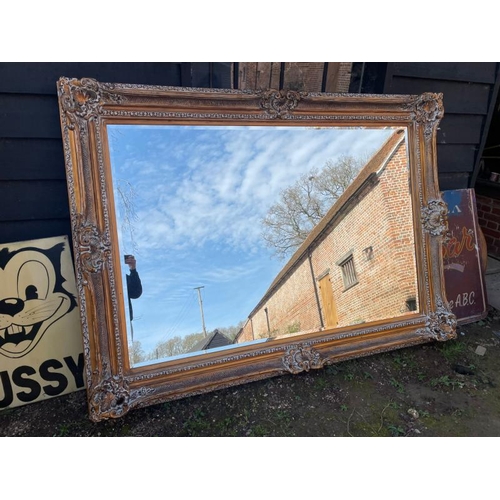 485 - Large 20th century oversized gilt mirror with bevelled plate, 222cm (w) x 161cm (h), the mirror meas... 