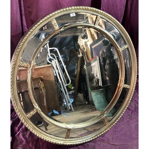 487 - A circular wall mirror with beviled edging and decorative dual frame design, 113cm (dia)  / All lots... 