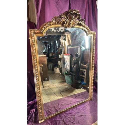 488 - A large 19th century wall mirror with gilt frame and ormolu style centrepiece, requires some restora... 