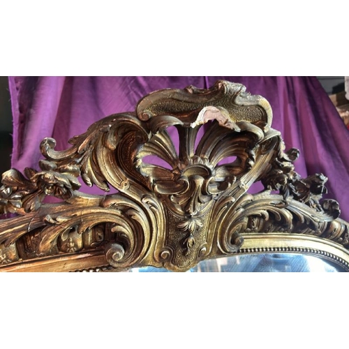 488 - A large 19th century wall mirror with gilt frame and ormolu style centrepiece, requires some restora... 