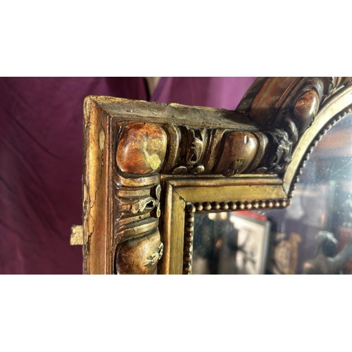 488 - A large 19th century wall mirror with gilt frame and ormolu style centrepiece, requires some restora... 