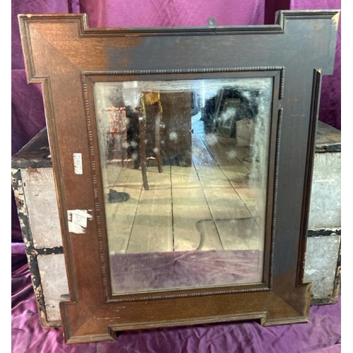 491 - A 20th century wall mirror with beviled edging, original glass and oak frame, requires some restorat... 