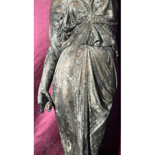 525 - A spelta figure of a classical maiden supporting a torch, with associated wooden hexagonal base, con... 