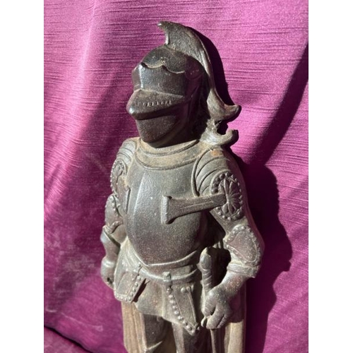 534 - A cast iron door stop of a medieval knight in armour, 52cm (h)  / All lots are located at The Barn, ... 