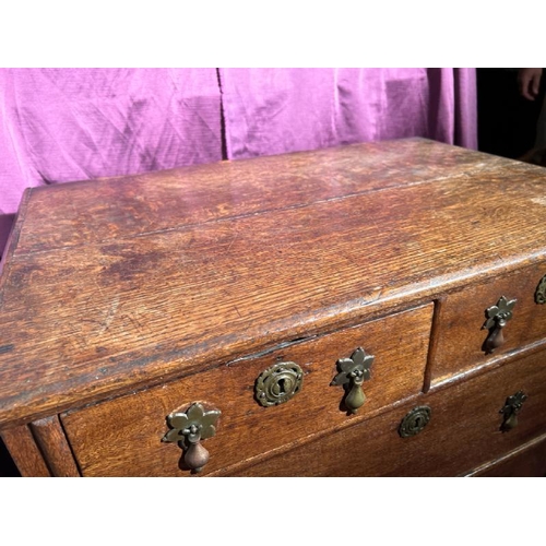 542 - An 18th century bachelorette's chest of drawers in oak with original brass fixtures, 79cm (h) x 80cm... 