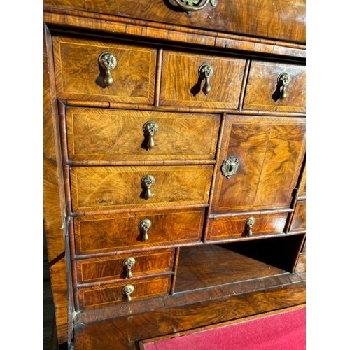 571 - An 18th century Queen Anne walnut escritoire on associated base, profusely carved and inlaid through... 