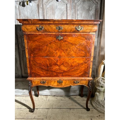 571 - An 18th century Queen Anne walnut escritoire on associated base, profusely carved and inlaid through... 