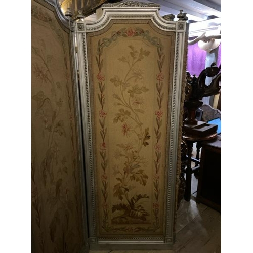 579 - A 19th century Louis XVI four panel screen with silvered paint finish and original needlework panels... 